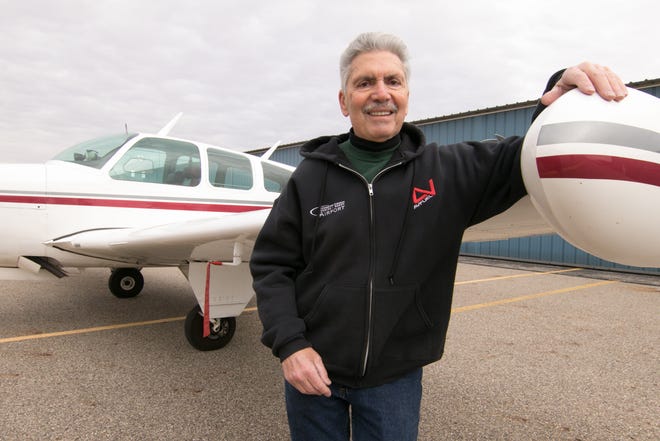 Mario Pecchia, an employee at the Spencer J. Hardy Airport in Howell, received the FAA Wright Brothers Master Pilot award. He stands at the wing of a 1967 Beechcraft Bonanza owned by his friend Ray Blach, outside a hangar at the airport Friday, Dec. 13, 2019.