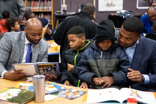 Xavier Purdy, from left, Tyrell Kirkwood, Tykese Kirkwood-Welch and Dameion Cowans read together during Fatherhood Friday on Dec. 13, 2019, at Buena Vista Elementary in Nashville.