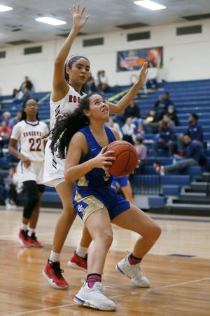 San Elizario's Victoria Perez goes against San Antonio Roosevelt defense in the McDonald's Girls Basketball Tournament Friday, Dec. 13, at Del Valle High School in El Paso.