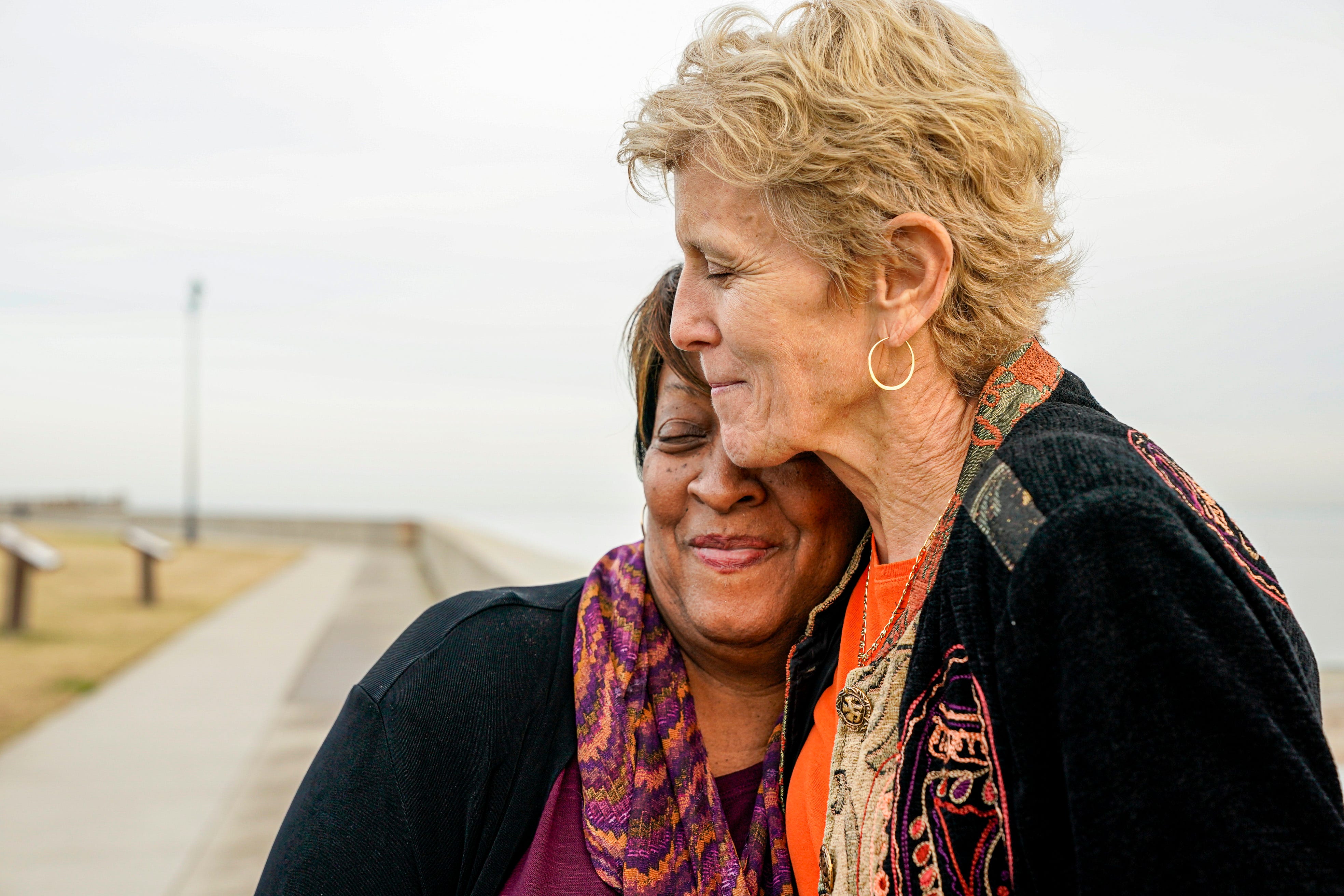 Wanda Tucker and Pam Tucker share a hug while visiting Point Comfort. Point Comfort is where the ship the White Lion arrived with "20 and odd" enslaved Africans in August 1619.