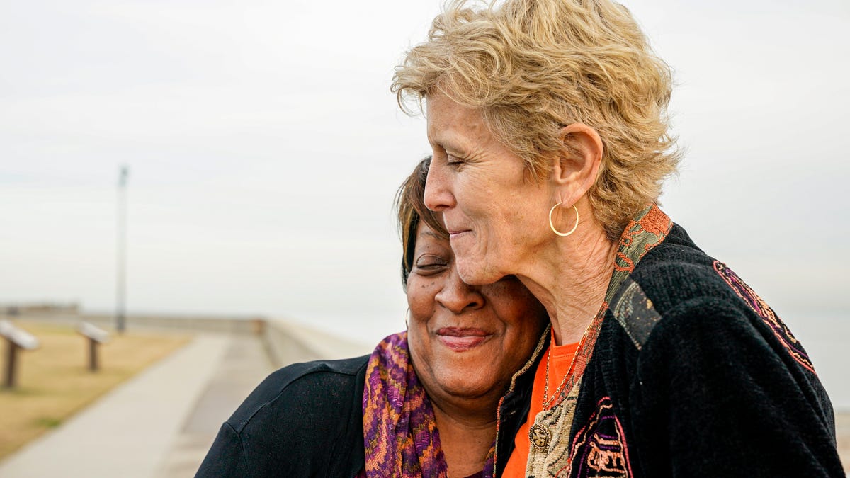 Wanda Tucker shares a hug with Pam Tucker while visiting Point Comfort in Hampton, Va.