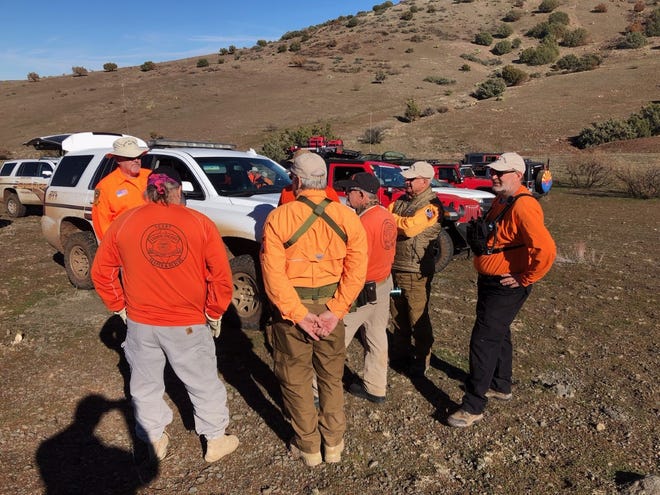 Yavapai County Search and Rescue Team volunteers gather near the crash site