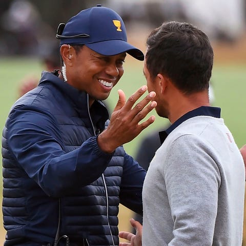 U.S. team captain Tiger Woods embraces Xander Scha