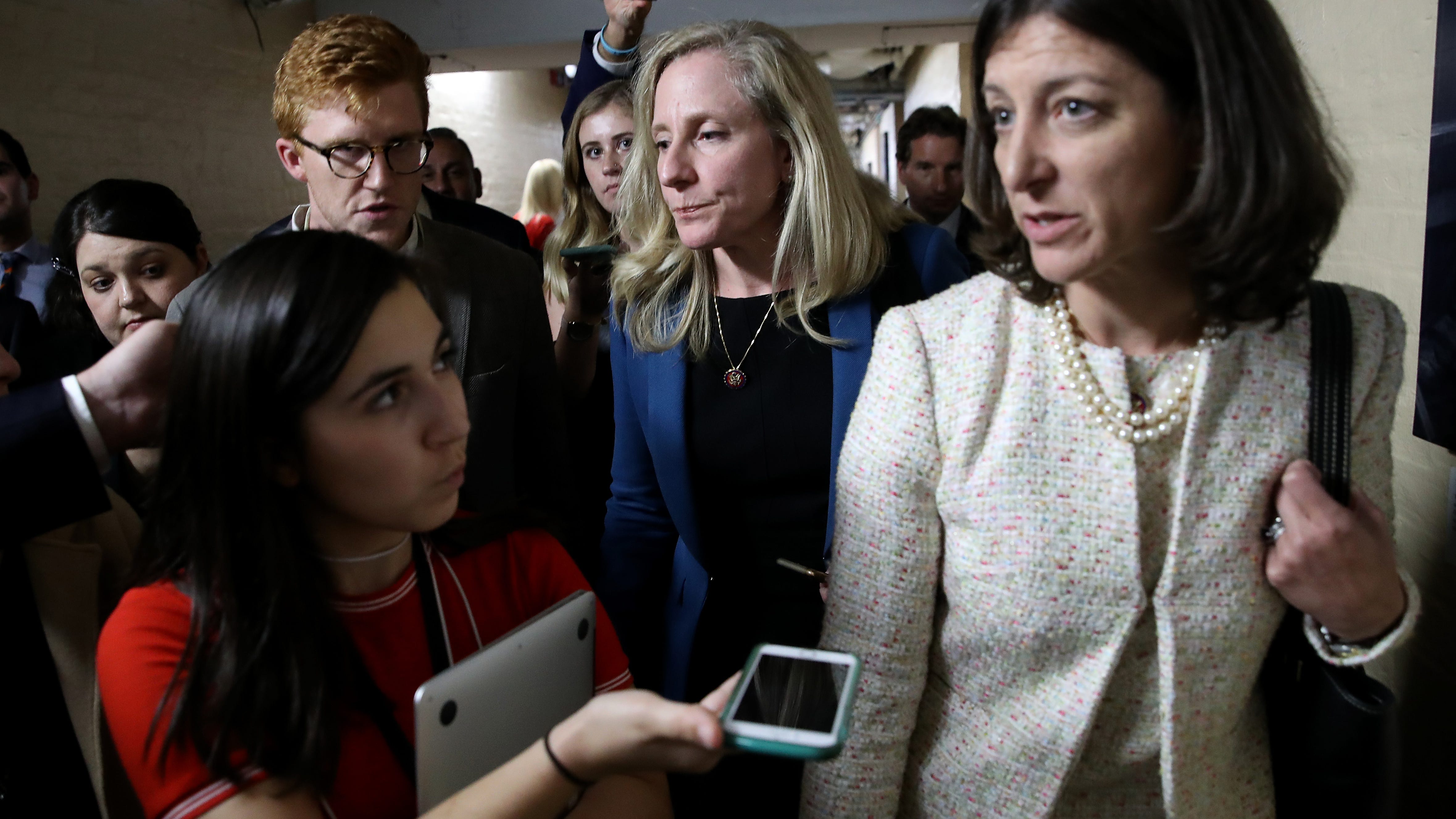 Rep. Abigail Spanberger (C) (D-VA) and Rep. Elaine Luria (R) (D-VA) are trailed by reporters after leaving a House Democratic caucus meeting at the U.S. Capitol where formal impeachment proceedings against U.S. President Donald Trump were announced by Speaker of the House Nancy Pelosi September 24, 2019 in Washington, DC.