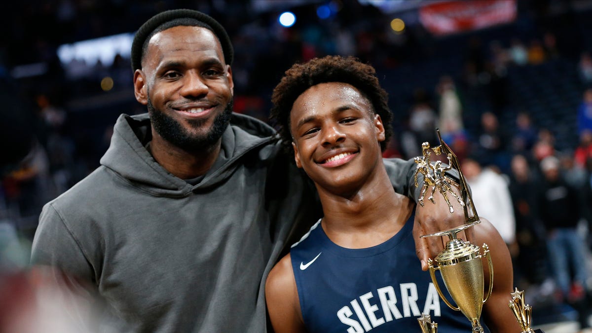 LeBron James, left, poses with his son Bronny after Sierra Canyon beat Akron St. Vincent - St. Mary in a high school basketball game Saturday.