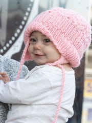 9-month-old Nora Beth Coombs flashes a smile while her family works from their Jericho Farmhouse food truck at Light Up La Grange on Dec. 7, 2019.