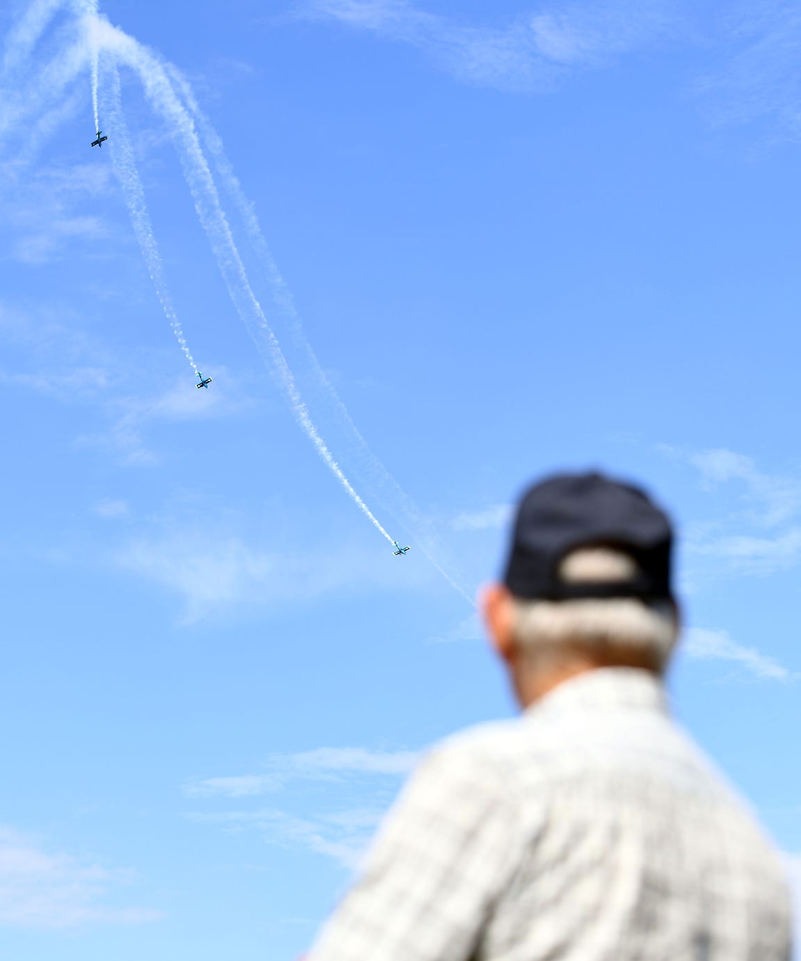 Paul Harms watches the Vanguard Squadron perform at the Sioux Falls Air Show on Saturday, August 17, 2019 at the South Dakota Air National Guard base. Harms said he used to work on a military tanker responsible for refeuling aircrafts mid-flight. 