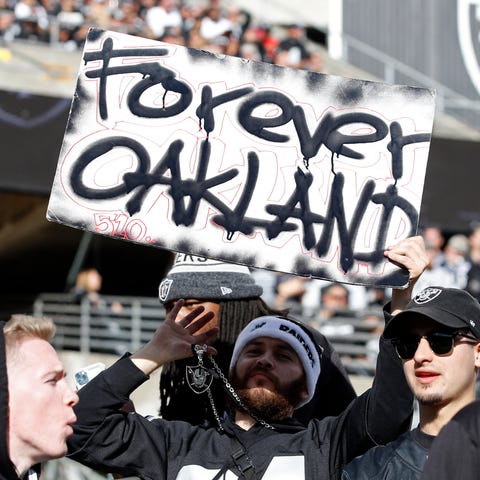 An Oakland Raiders fan holds up a sign during the 
