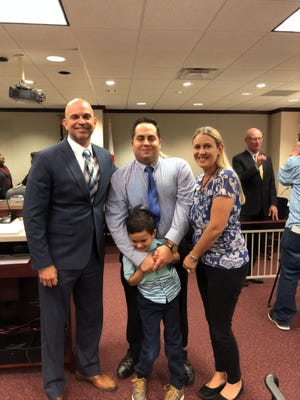 Jonathan Pogar, son Andrew and wife Heather, pose with State Rep. Rene Plasencia at a Dec. 11 subcommittee hearing on H.B. 575, which would allow RBTs into Florida schools.