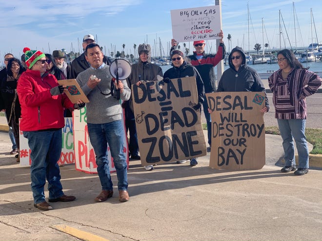 Eric Rodriguez, front, chairman of the Coastal Bend Sierra Club, delivers prepared comments opposing desalination discharge in Corpus Christi Bay. Rodriguez was one of several speakers during a protest Tuesday.