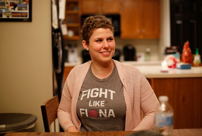 Beth Brubaker recalls her fight with breast cancer at her Campbell County home on Monday. She was diagnosed with it just a few days before she learned she was pregnant. A colleague of her husband, Jason Brubaker, gave her this 'Fight like Fiona' T-shirt, which Beth says inspired her during her treatment and pregnancy.