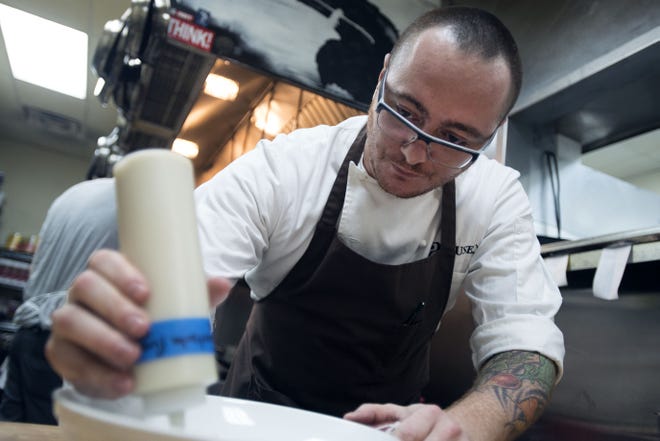 Chef Hari Cameron dresses the plate for a wild mushroom dish at his restaurant, a(MUSE.) in Rehoboth Beach.