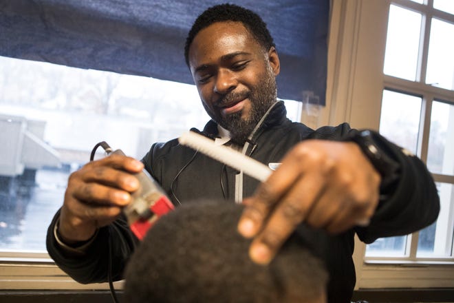 Warner Elementary principal Terrance Newton shapes up student Brandon Ponzo Monday, Dec. 16, 2019 at the school. The makeshift barbershop gives Newton a chance to bond with his students in a more casual setting and keep his students looking sharp. 