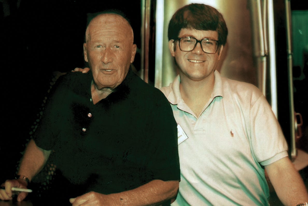 Mystery writers and friends Mickey Spillane and Iowa native Max Allan Collins pause while signing books at a convention.