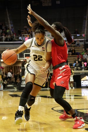Purdue forward Jenelle Grant (22) drives to the net under Western Kentucky forward Fatou Pouye (12) during the first quarter of a NCAA women's basketball game, Wednesday, Dec. 18, 2019 at Mackey Arena in West Lafayette.