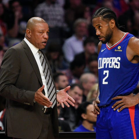 Clippers forward Kawhi Leonard, right, speaks with