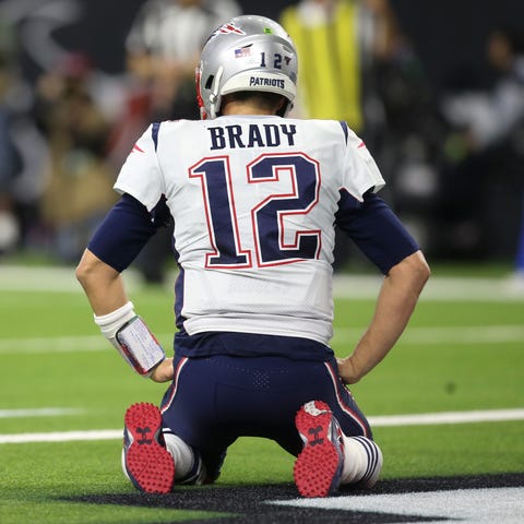 New England Patriots quarterback Tom Brady (12) re