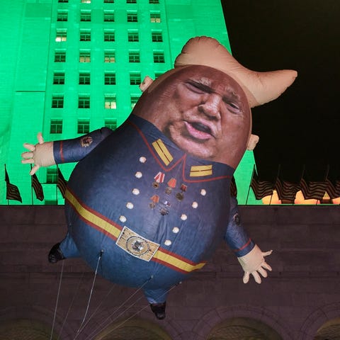 A Baby Trump balloon floats outside City Hall in L