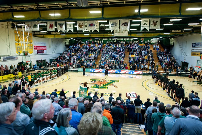The teams listen to the National Anthem during the men's basketball game between the UNC Greensboro Spartans and the Vermont Catamounts at Patrick Gym on Wednesday night December 18, 2019 in Burlington, Vermont.
