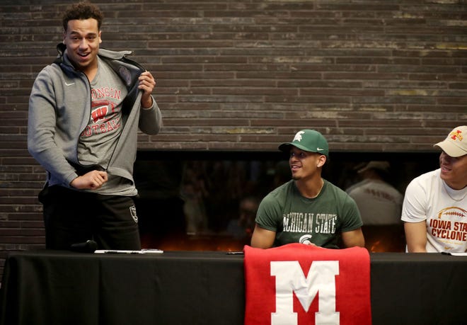 Minnehaha Academy football players Kaden Johnson, from left, Terry Lockett Jr., Craig McDonald made their college football plans official and signed letters of intent Wednesday.  Johnson is headed to the University of Wisconsin, Lockett to Michigan State and McDonald to Iowa State.