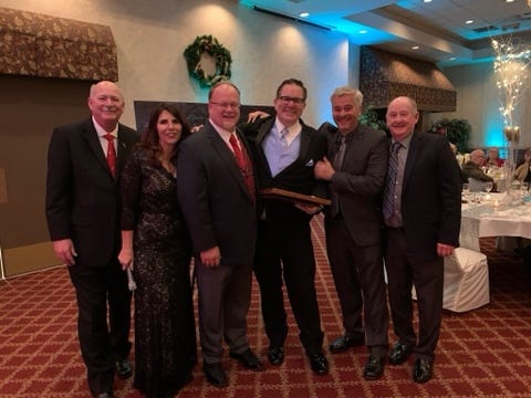 Todd Hibberd, center, was honored by the Huron Valley Chamber of Commerce as the 2019 Citizen of the Year. He is surrounded by (from left) Ron Fowkes, Joell Beether, Jim Runestad, Rick Kirchner and Bob Hoffman.
