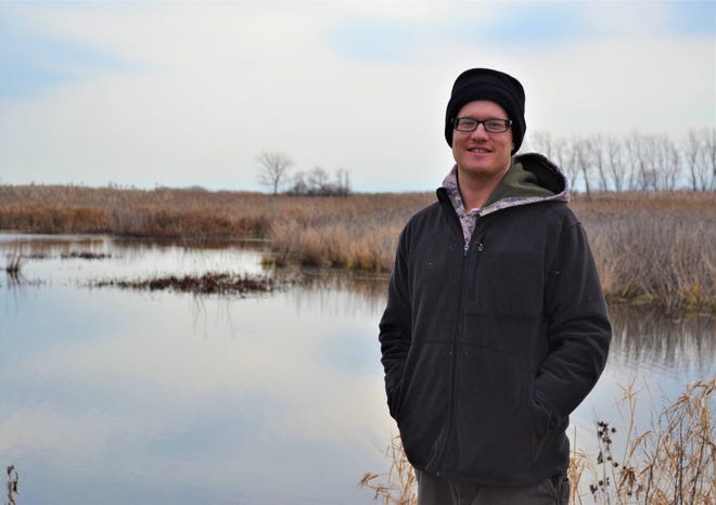Winous Point Research Coordinator Brendan Shirkey stands at Winous Point Marsh Conservancy. A major element of his job is to manage the wildlife on the conservancy grounds, including the birds that summer there.