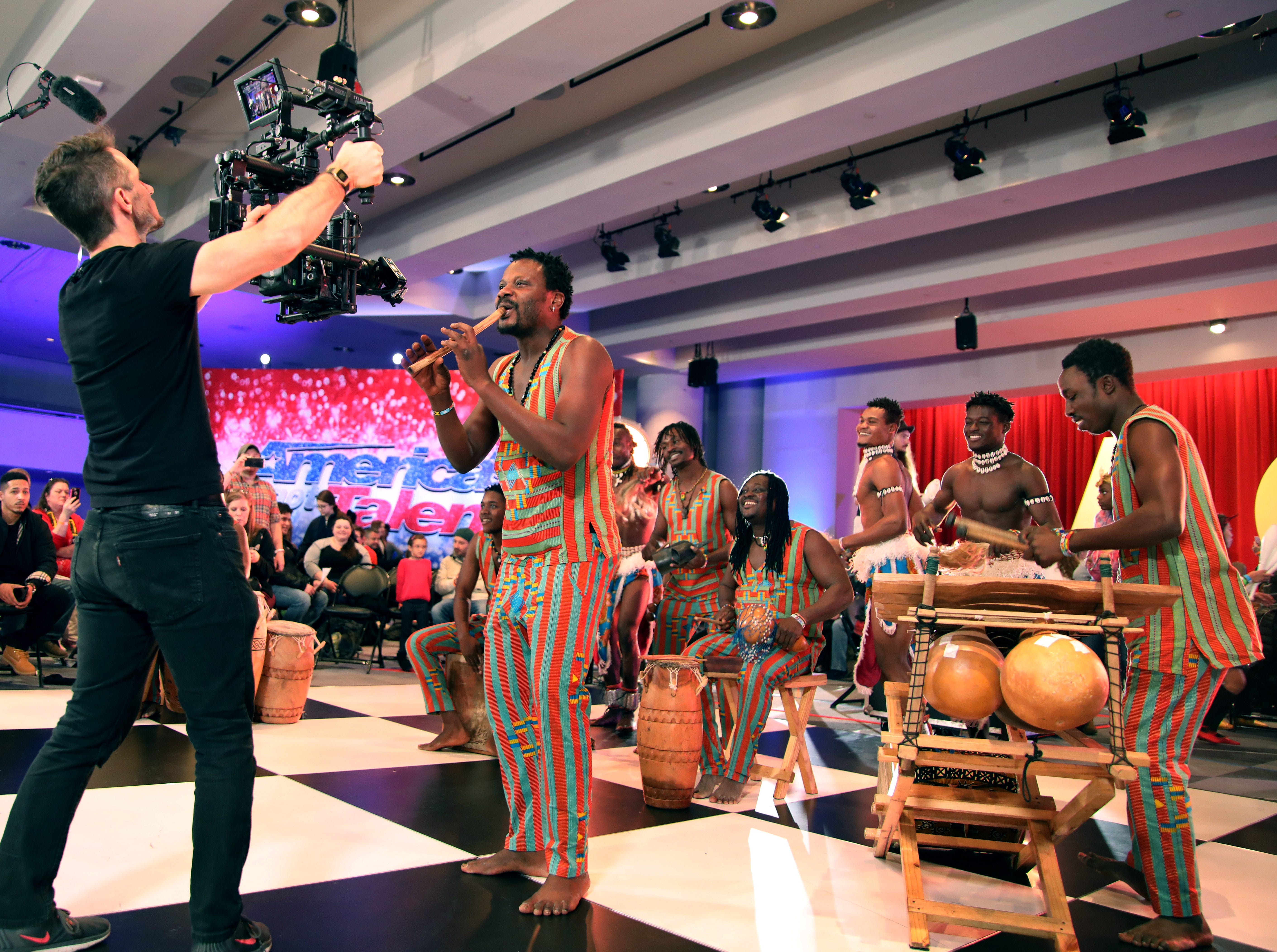 Stephen Nanakojo Asare plays the flute as other members of Womba Africa accompany him in the holding room of 'America's Got Talent' auditions.
