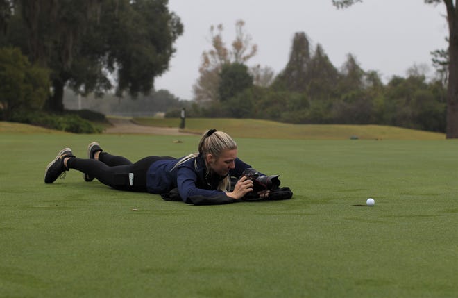 Tallahassee Democrat photographer Alicia Devine works on All-Big Bend photos during a photo shoot at Killearn Country Club on Dec. 11, 2019.