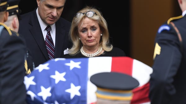 Rep. Debbie Dingell, D-Mich., watches as her husba