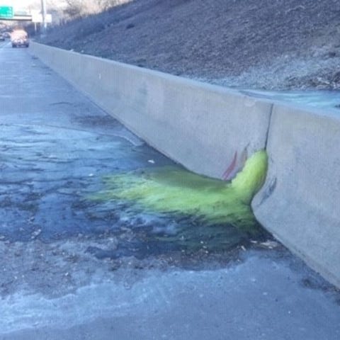 A greenish-yellow liquid flows through a retaining
