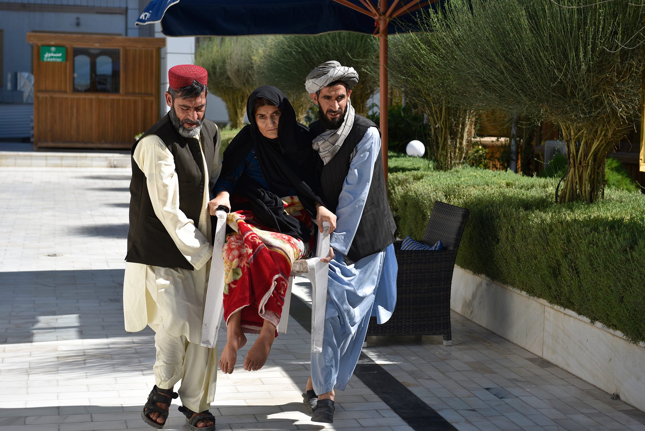 Gul Rukh, a survivor of the raid in Azizabad, is still paralyzed from the waist down from the shrapnel that embedded in her spine. She cannot afford a wheelchair so her brother must carry her.