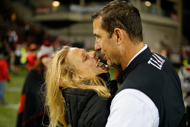 Cincinnati Bearcats head coach Luke Fickell gets a hug and kiss from his wife Amy after the final play of the fourth quarter of the NCAA American Athletic Conference game between the Cincinnati Bearcats and the Temple Owls at Nippert Stadium in Cincinnati on Saturday, Nov. 23, 2019. The Bearcats clinched the AAC East championship with a 15-13 win over Temple.