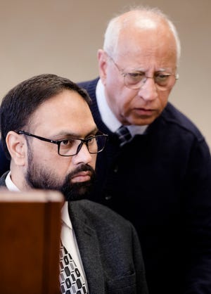 Gurpreet Singh, accused of shooting and killing his wife, and three in-laws in April 2019, listens to Kartar Singh, an unrelated court interpreter, during a hearing in Judge Gregory J. Howard's Butler County courtroom in Hamilton on Monday, Dec. 23, 2019. 