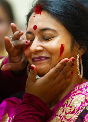 Sukanya Gupta of Newburgh celebrates Durga Puja with traditional red powder galled gulal at the Tri-State Hindu Temple, Newburgh, Sunday, Oct. 6, 2019.