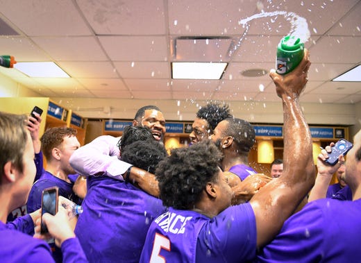 Evansville head coach Walter McCarty celebrates with the Aces in the locker room after the gameas the University of Evansville Purple Aces defeat the number one ranked Kentucky Wildcats 67-64 at Rupp Arena in Lexington Tuesday evening, November 12, 2019.