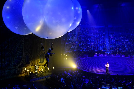 Valentyna Pahlevanyan, left, leaves Mauro the Dreamer Clown, played by Lolo Fernández, on stage to float around the crowd from three large balloons during Cirque du Soleil's Corteo show at Ford Center in Evansville, Ind., Wednesday night, Jan. 23, 2019. 