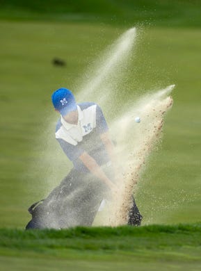 Memorial's Justin Drake hits out of the bunker at the 10th hole at Victoria National Golf Club Saturday afternoon.