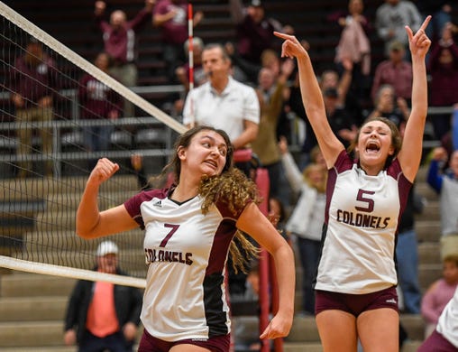 Henderson’s Kaylee Stott (7) and Asha Nalley (5) react after the winning match point as the Henderson County Lady Colonels play the University Heights Lady Blazers for the Second Region volleyball tournament championship at Madisonville-North Hopkins High School Thursday evening, October 31, 2019.