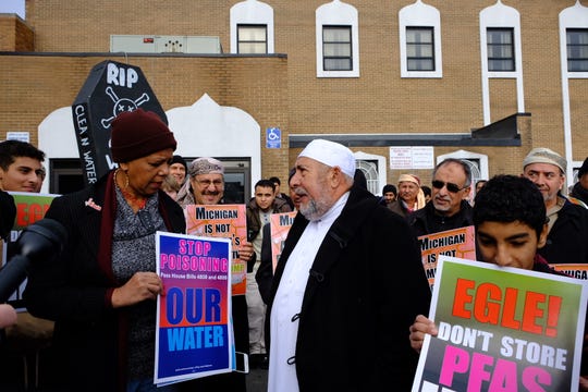 Imam Salah Algahelm, right, telling Rep. Cynthia Johnson, "We don't want this here, it's very dangerous for everybody."