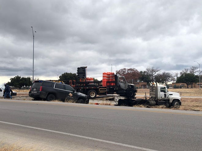 A semi-truck stands parked off West Loop 306 near the Knickerbocker Exit after it caught fire Friday, Dec. 27, 2019.