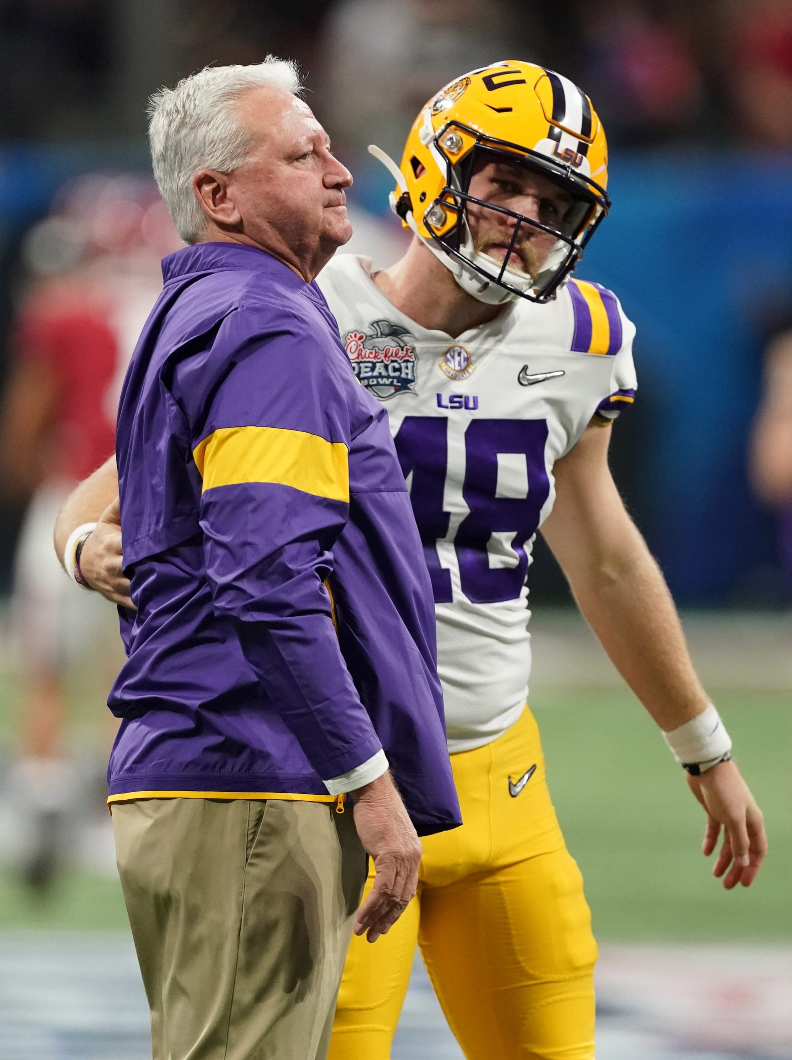 Dec 28, 2019; Atlanta, Georgia, USA; LSU Tigers offensive coordinator/quarterbacks coach Steve Ensminger reacts with long snapper Blake Ferguson (48) before the 2019 Peach Bowl college football playoff semifinal game against the Oklahoma Sooners. Mandatory Credit: John David Mercer-USA TODAY Sports