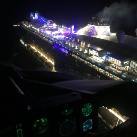 A Coast Guard helicopter flies over the Anthem of 