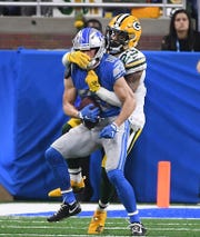 The Lions' Danny Amednola is tackled by the Packers' Jaire Alexander, who is flagged for unnecessary roughness in the second quarter.