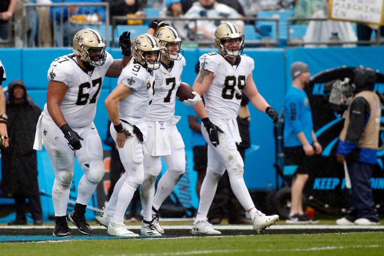 New Orleans Saints quarterback Taysom Hill (7) is congratulated following Hill's touchdown by offensive guard Larry Warford (67), quarterback Drew Brees (9) and tight end Josh Hill (89) during the second half of an NFL football game against the Carolina Panthers in Charlotte, N.C., Sunday, Dec. 29, 2019. (AP Photo/Brian Blanco)