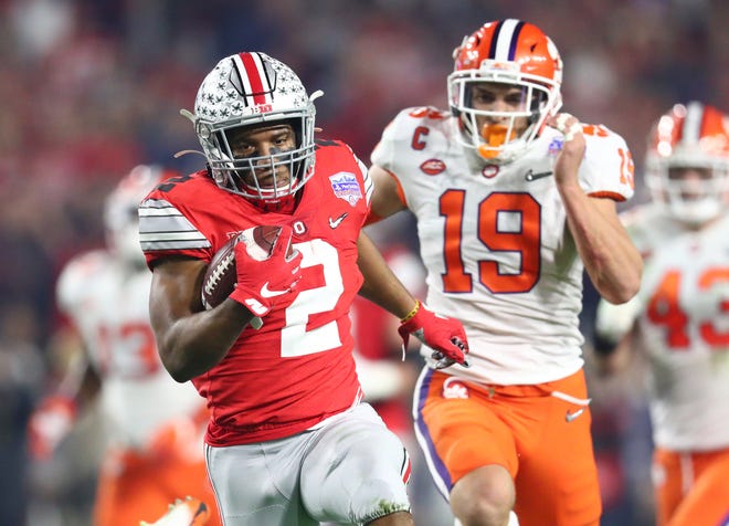 Ohio State tailback J.K. Dobbins runs for a 68-yard touchdown in the first quarter of Saturday's 29-23 loss to Clemson in the College Football Playoff semifinal at the Fiesta Bowl.