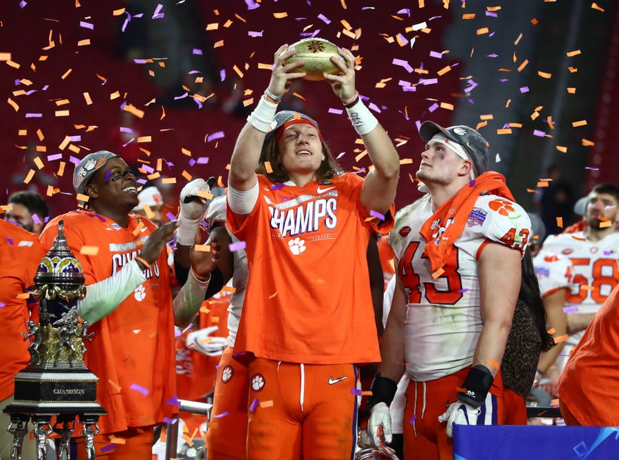 Tigers quarterback Trevor Lawrence (16) celebrates with the trophy after defeating the Buckeyes in the 2019 Fiesta Bowl.