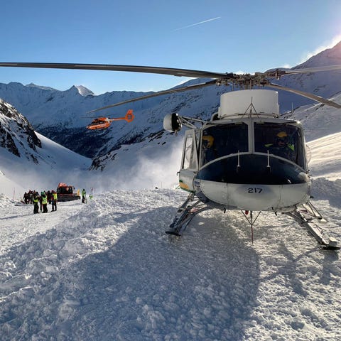 Rescuers at work following an avalanche in Val Sen