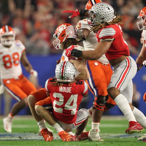 Clemson QB Trevor Lawrence is hit by Ohio State's 