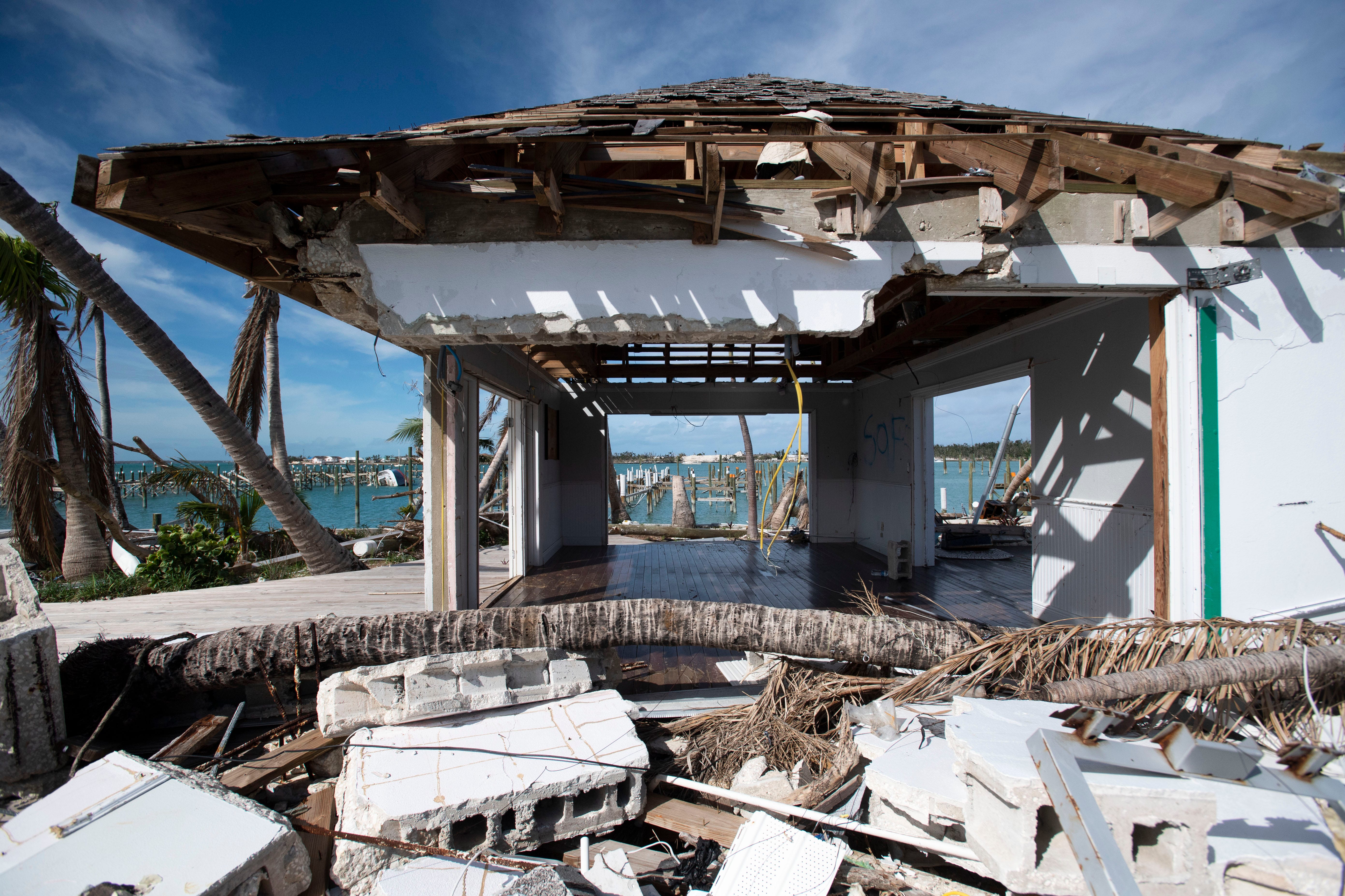 A shell of Mangoes Marina and Restaurant still stands Saturday, Dec. 21, 2019, nestled among a stretch of resorts and marinas that have been demolished by Hurricane Dorian in Marsh Harbour, Bahamas.