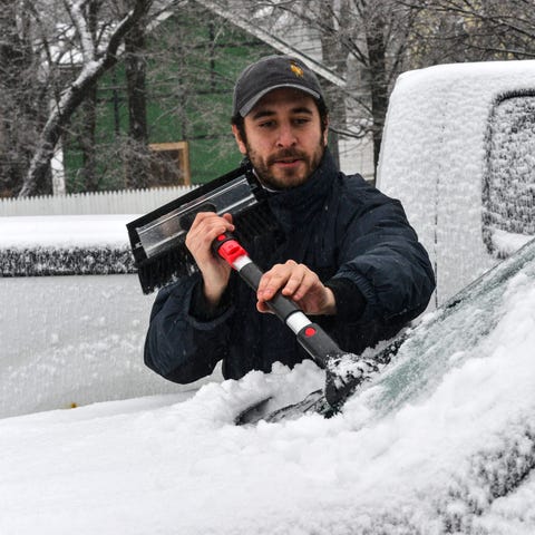 Zack Subarsky, from NYC, chips away the ice from a